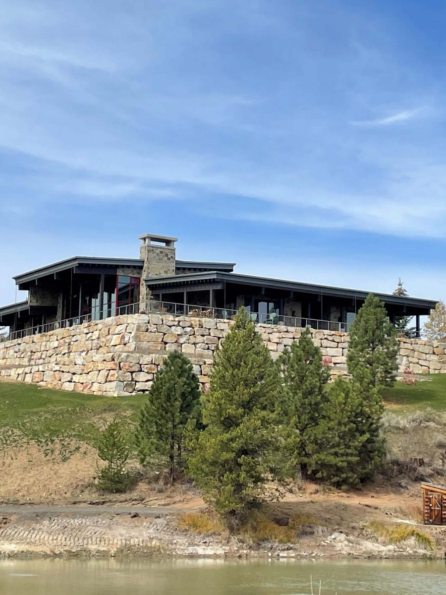House in McCall with large rock wall surrounding the base.