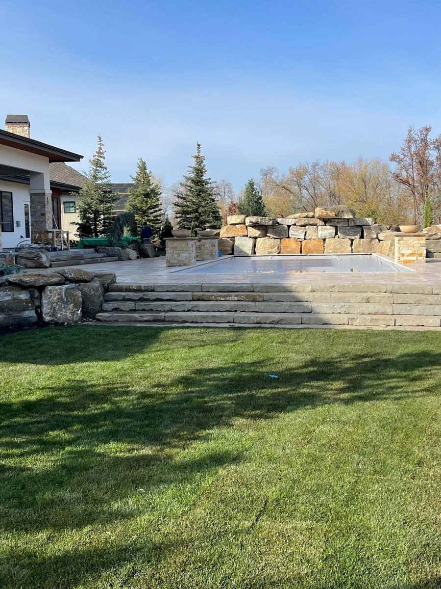 Outdoor pool with decorative rock siding.